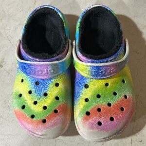 Size J2 multi colored crocs, gently used by 1 child. Good condition.